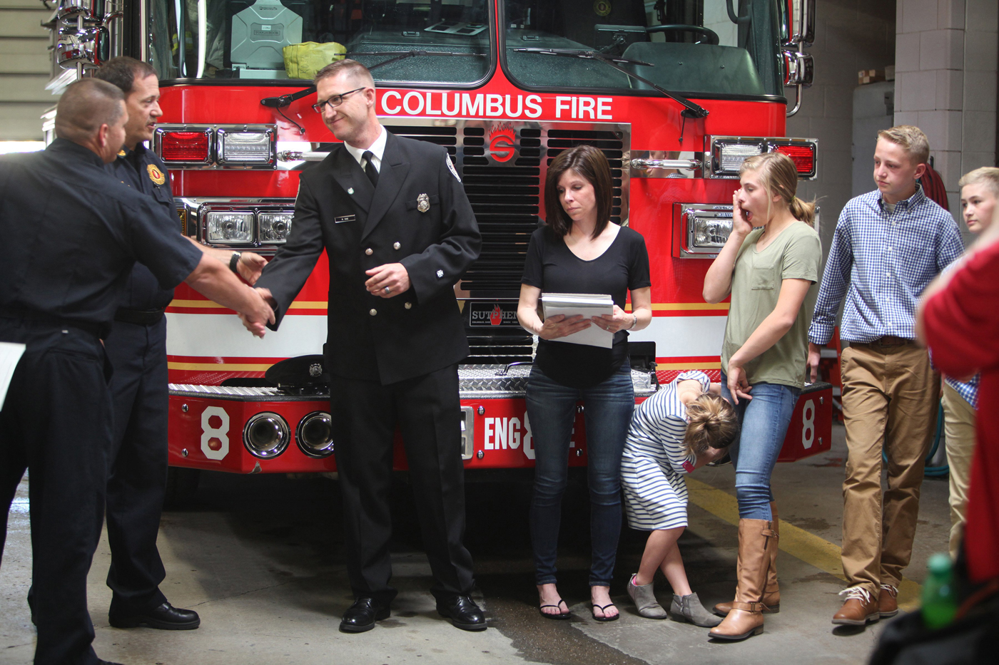 Mark Rine listens as a proclamation is read in his honor as he was named Firefighter of the Month on April 18, 2017. Beside Rine is his wife, Heather, and children Halle, Shelby, Blake and Cohen. The ceremony was held at his old firehouse, Station 8, at Long and Champion on the Near East Side. | Doral Chenoweth III