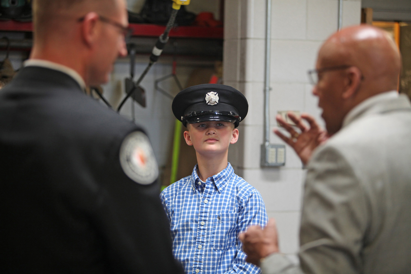 Cohen Rine wears his father's firefighting hat as his dad, Columbus firefighter Mark Rine, went back to his old firehouse, Station 8 at Long and Champion on the Near East Side, when he named Firefighter of the Month .