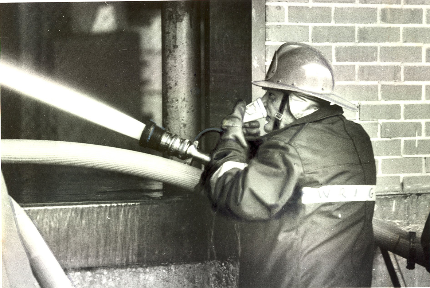 1984: Columbus firefighter Paul Wright drinks a cup of coffee while manning a hose at old Federal Glass on Marion Road.  | Dispatch file photo